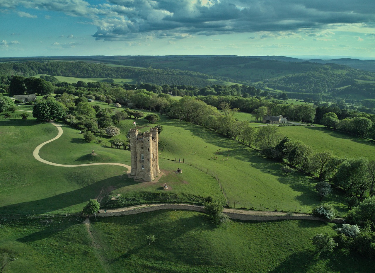 Broadway Tower standing on a grassy ridge overlooking the scenic Cotswold countryside.