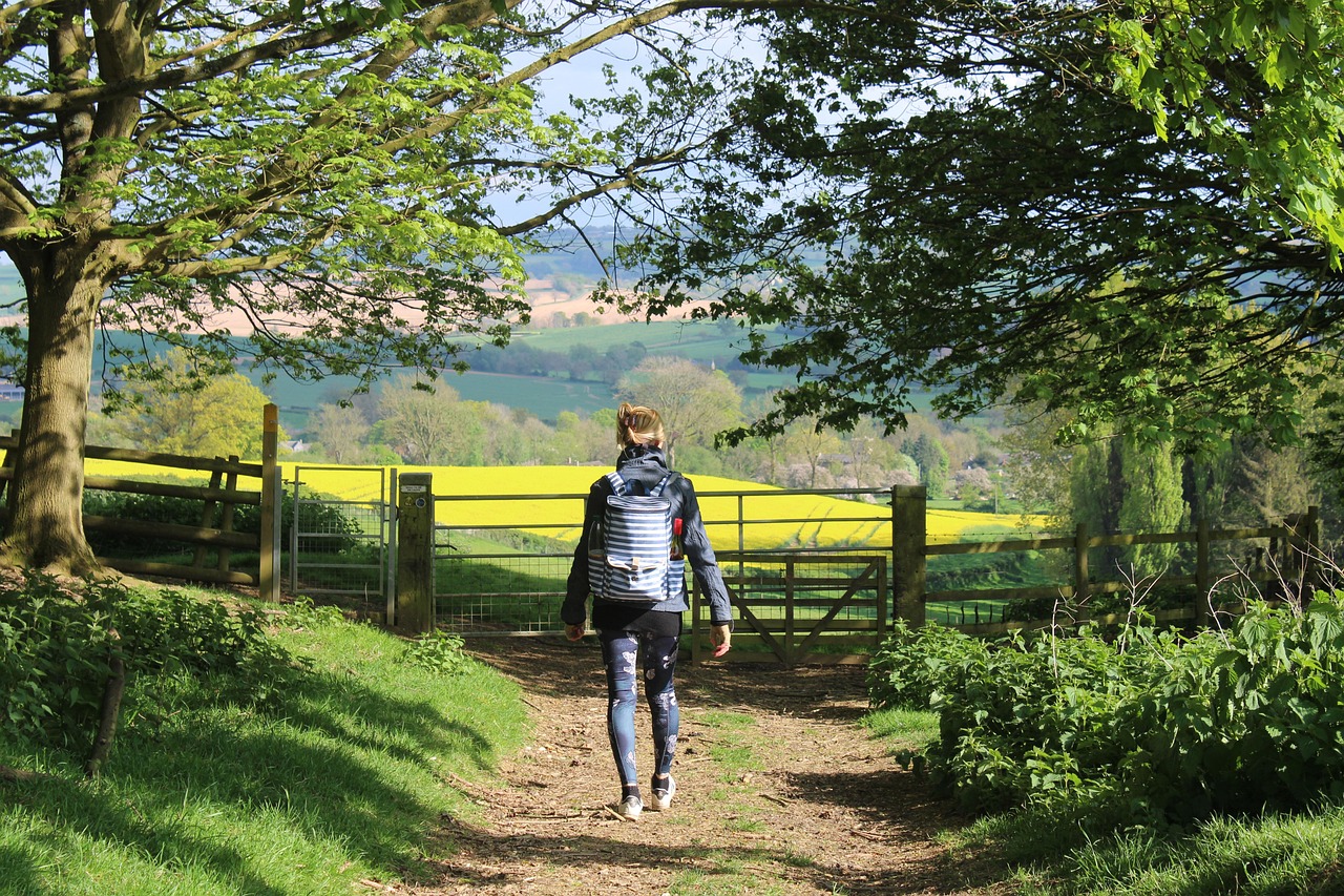 Walker on the Cotswold Way overlooking the Cotswold countryside