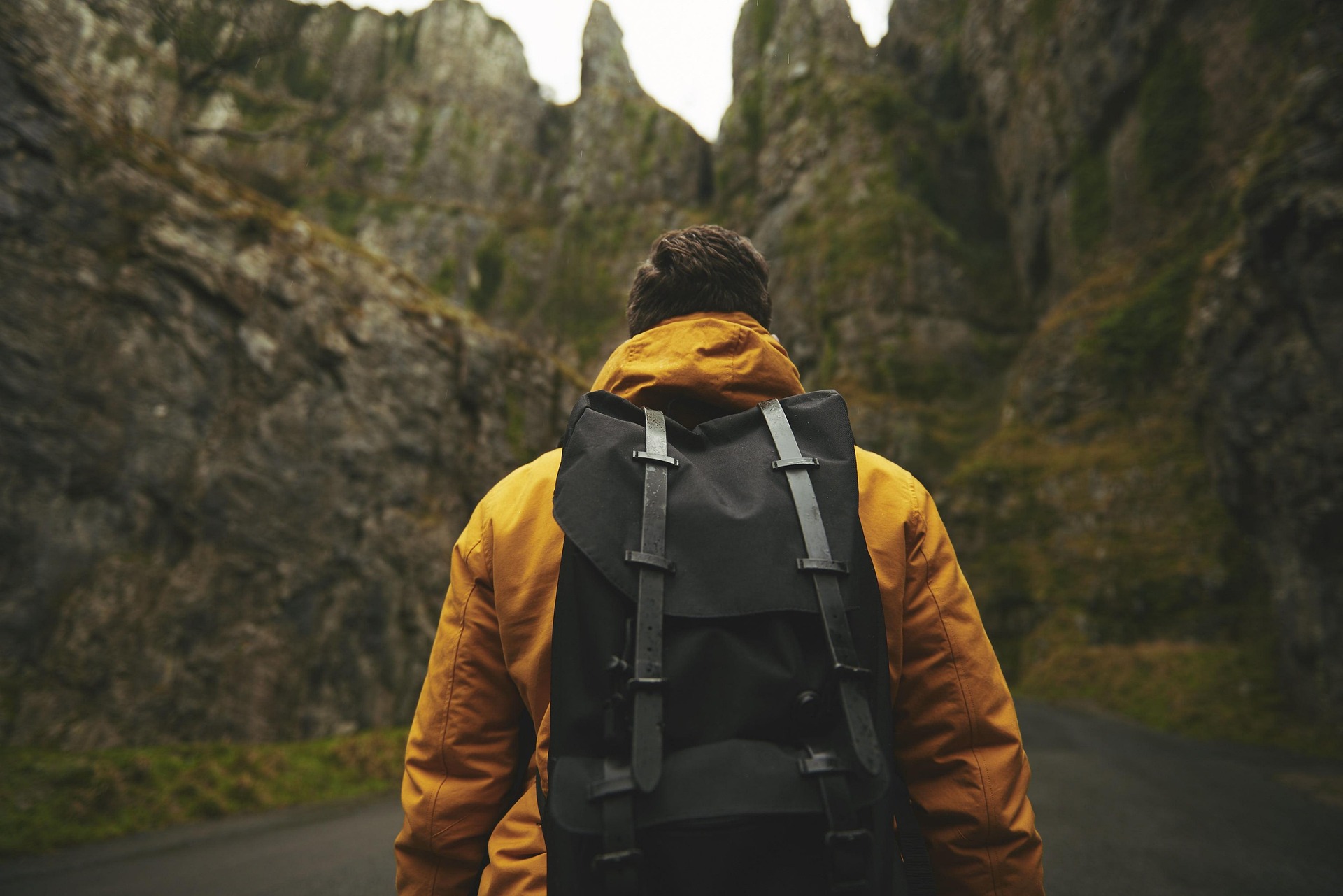 A hiker in the wilderness with a mountain in front of him, busy on his self-guided adventure