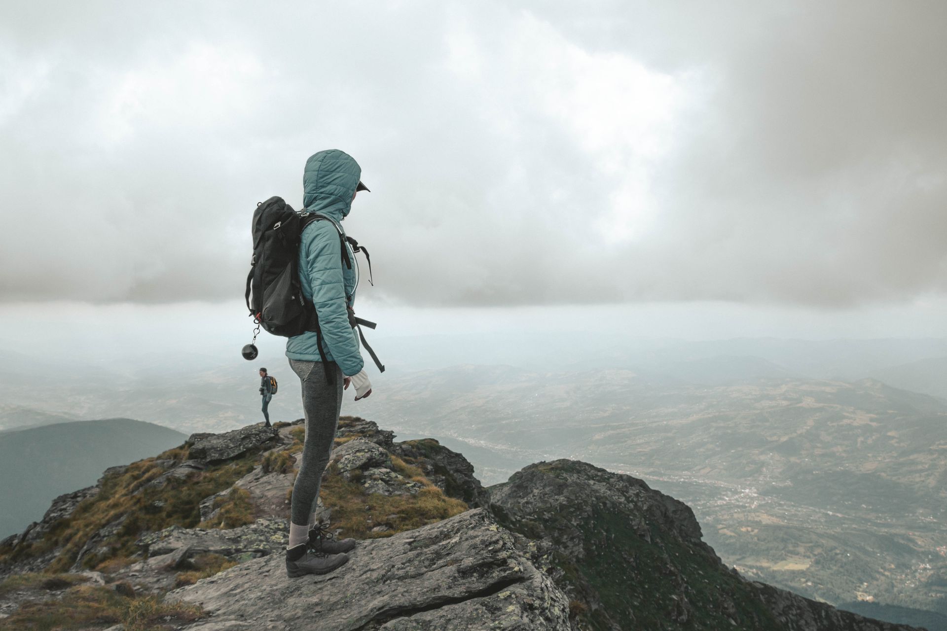 A lady pausing to take in the view on a misty self-guided walking adventure.