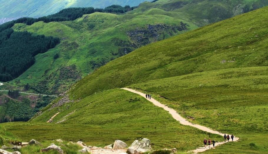 Hikers ascending Ben Nevis during a guided Three Peaks mountain challenge.